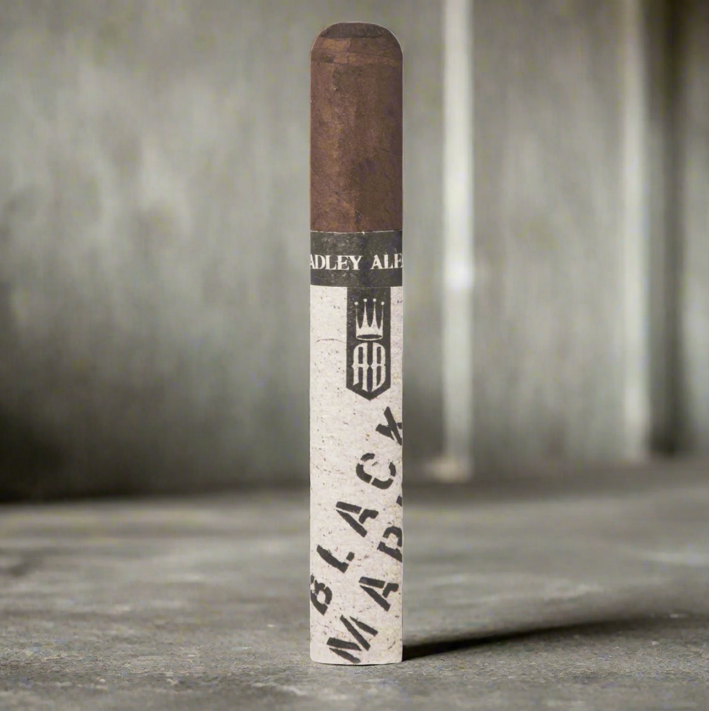 A single Alec Bradley black market punk cigar against a brutalist concrete background.