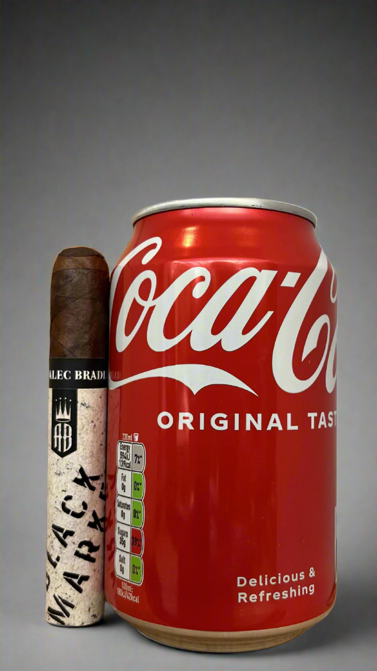 A single Alec Bradley black market punk cigar next to a can of cola to show scale.
