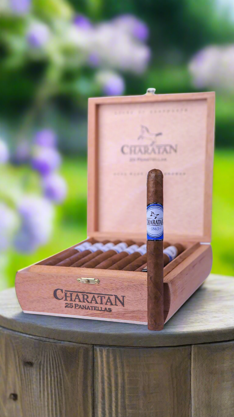 A box of Charatan panetela cigars in a sunny British garden.