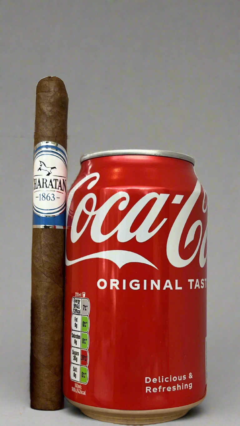 A single Charatan panetela cigar next to a can of coca cola, the cigar is about 30% longer than the can.