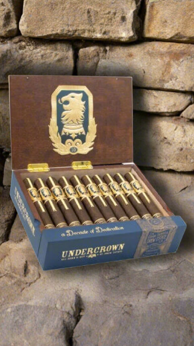 A box of Drew Estate Undercrown 10 Robusto against a medieval backdrop