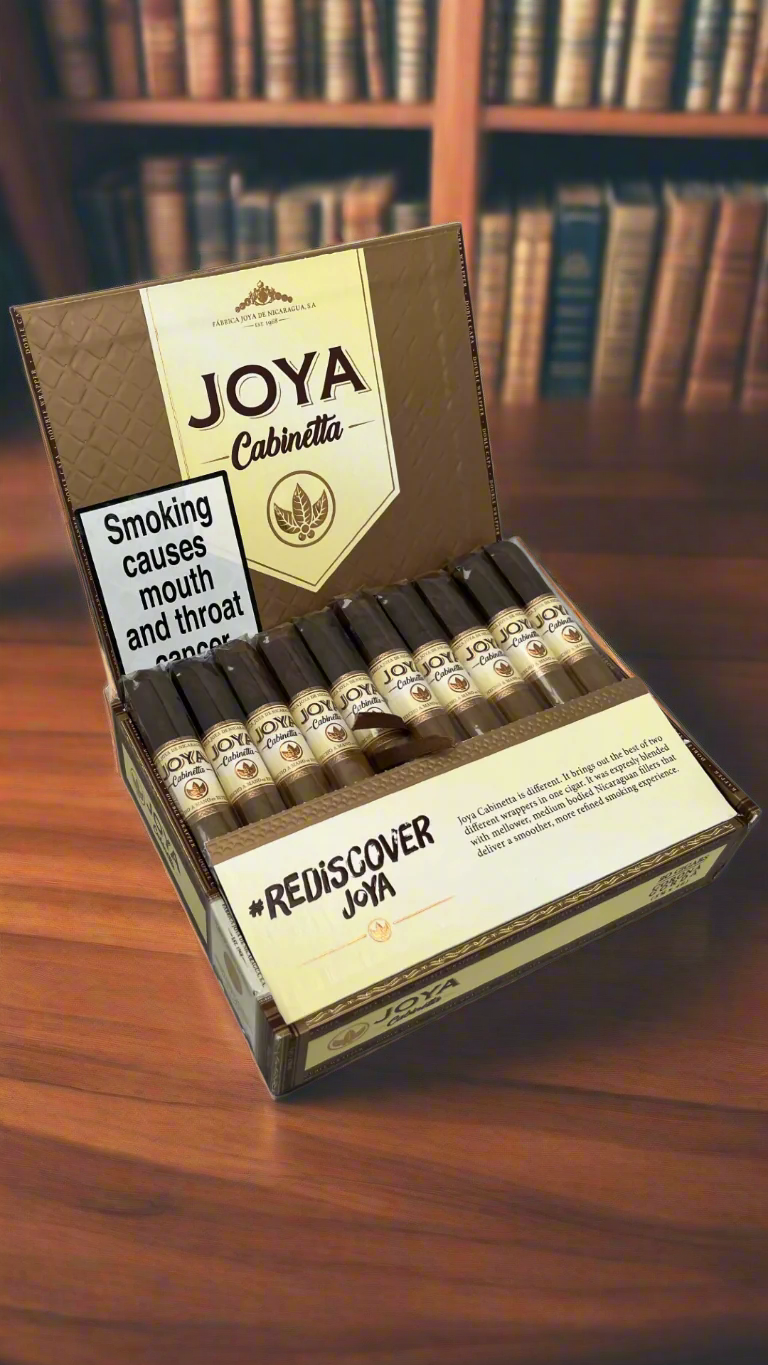 A box of Joya De Nicaragua Cabinetta Corona Gorda cigars in a library.