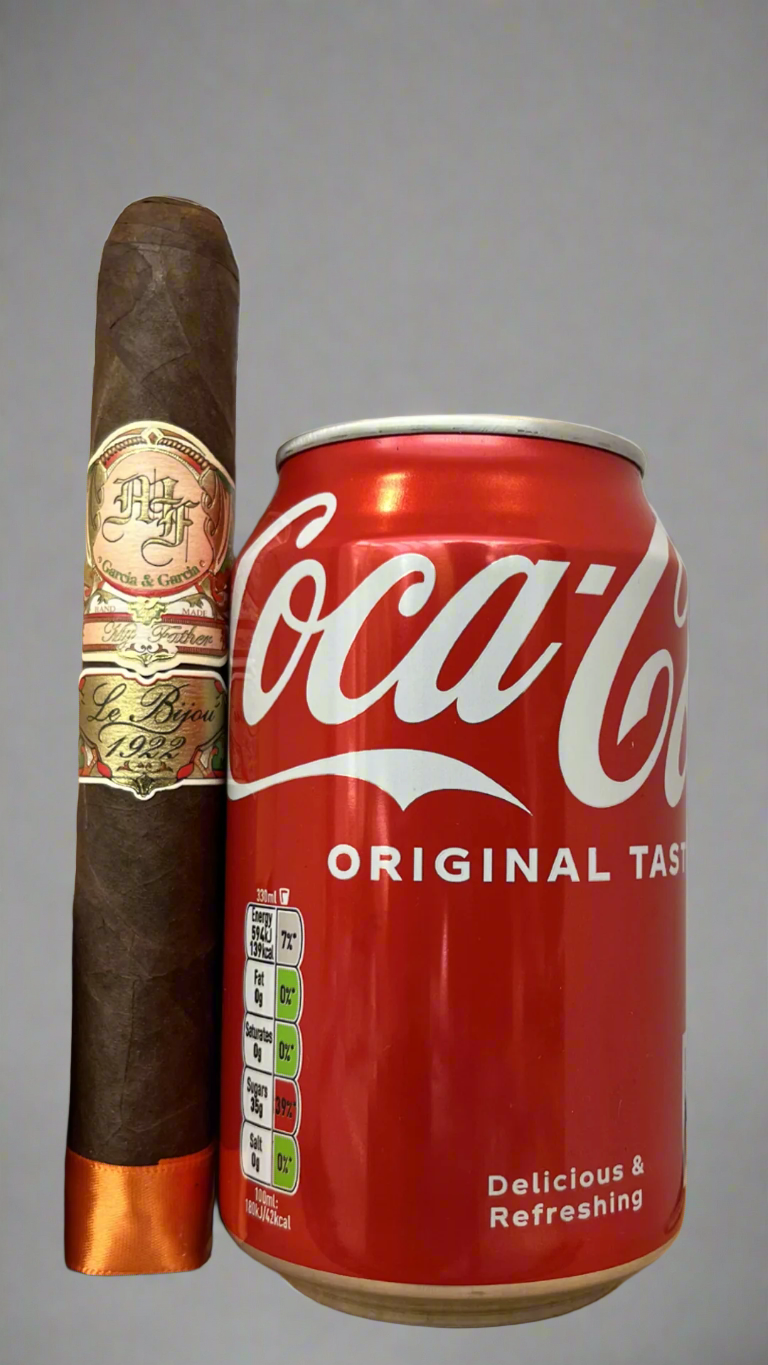 A single My Father Le Bijou 1922 Toro cigar next to a can of coca cola to show sale, the cigar is about 20% longer than the can.