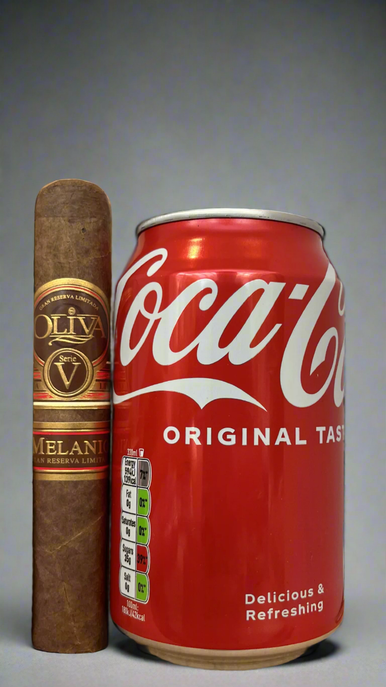 A single Oliva Serie V Melanio Robusto cigar next to a can of coca cola to show scale, the cigar is a few centimetres longer than the can.