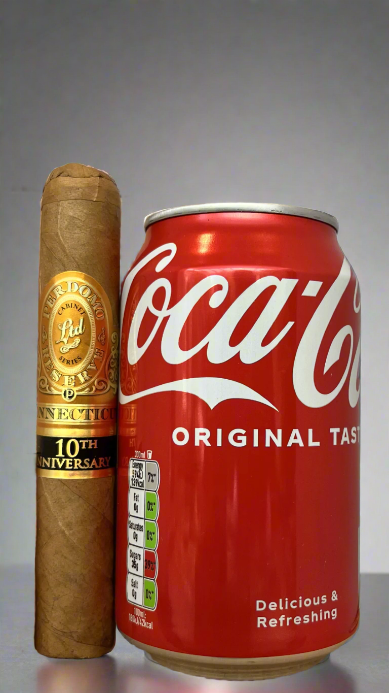 A single Perdomo 10th Anniversary Connecticut Robusto Cigar next to a can of coca cola to show scale, the cigar is a few centimetres longer than the can.