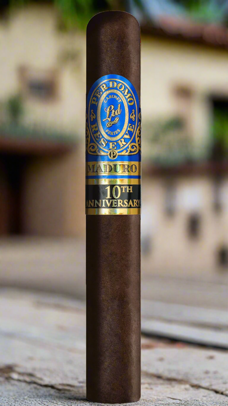A single Perdomo 10th Anniversary Maduro Epicure cigar in a Mexican farmhouse courtyard.