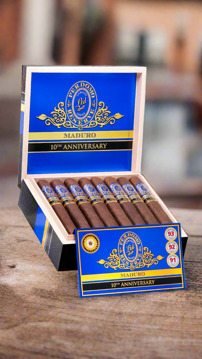 A box of Perdomo 10th Anniversary Maduro Epicure cigars on a wooden table in a the courtyard of a mexican farmhouse.