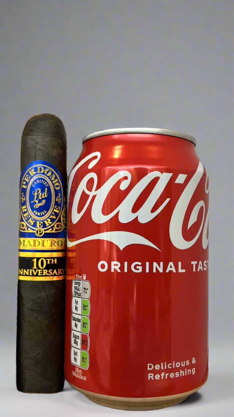 A single Perdomo 10th Anniversary Maduro Epicure cigar next to a can of coca cola to show scale, the cigar is a few centimetres longer than the can.