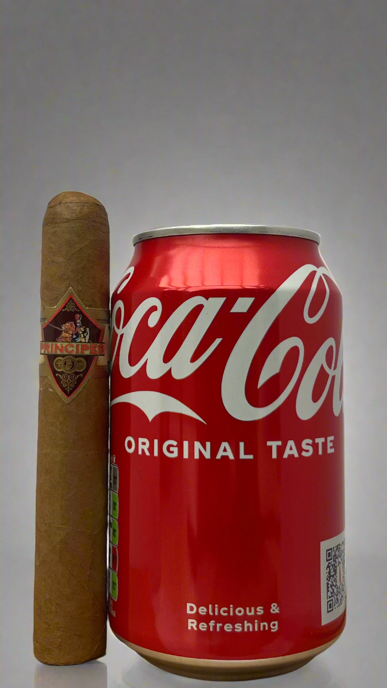 A single Principes Long Filler Claro Robusto Cigar next to a can of coca cola to show scale, the cigar is a few centimetres longer than the can.
