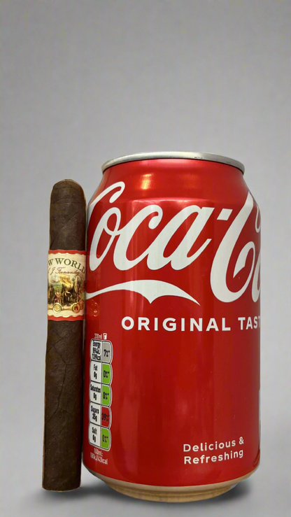 A single A.J. Fernandez New World Oscuro cigar against a can of cola to show the scale, they are about the same length.