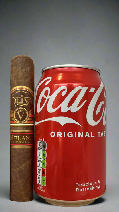 A single Oliva Serie V Melanio Robusto cigar next to a can of coca cola to show scale, the cigar is a few centimetres longer than the can.